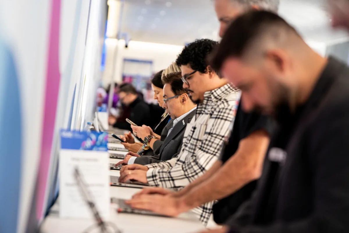 Attendees checking in on laptops at the RSAC conference registration — First Sight Films corporate event photography