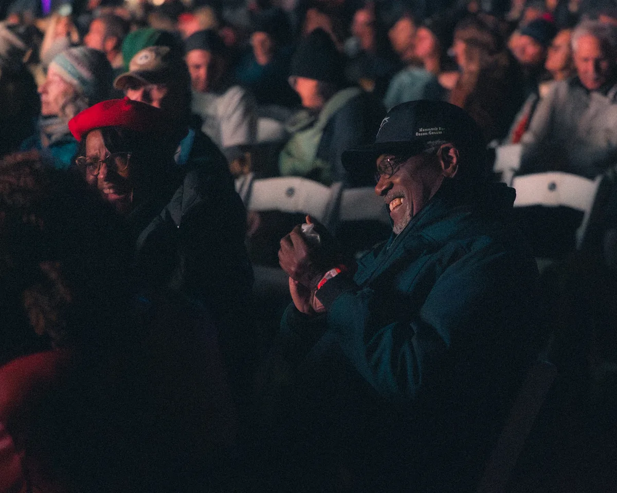 Wide shot of outdoor amphitheater crowd and stage