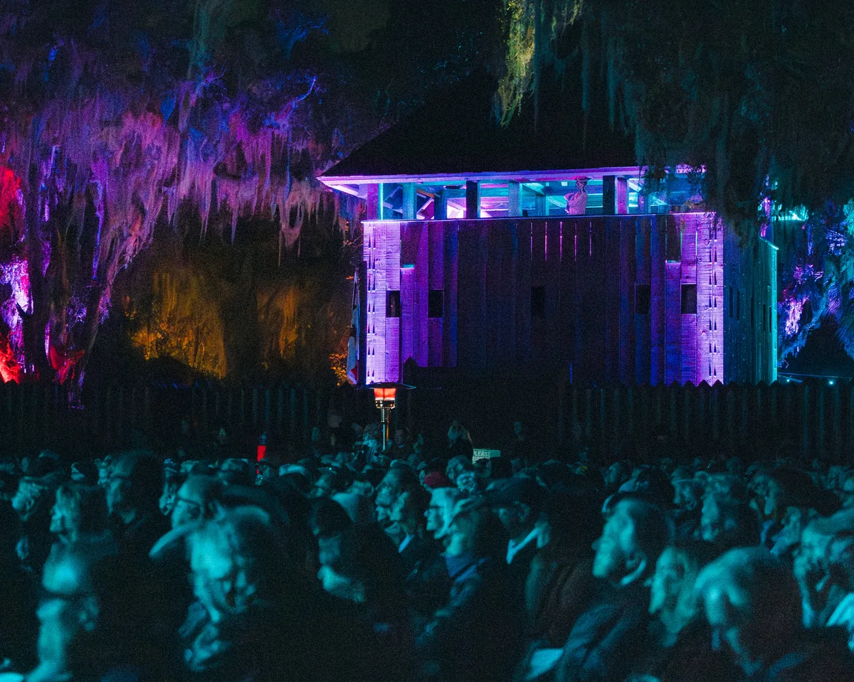 Large crowd gathered at illuminated outdoor concert stage at Fort Mose Jazz Festival