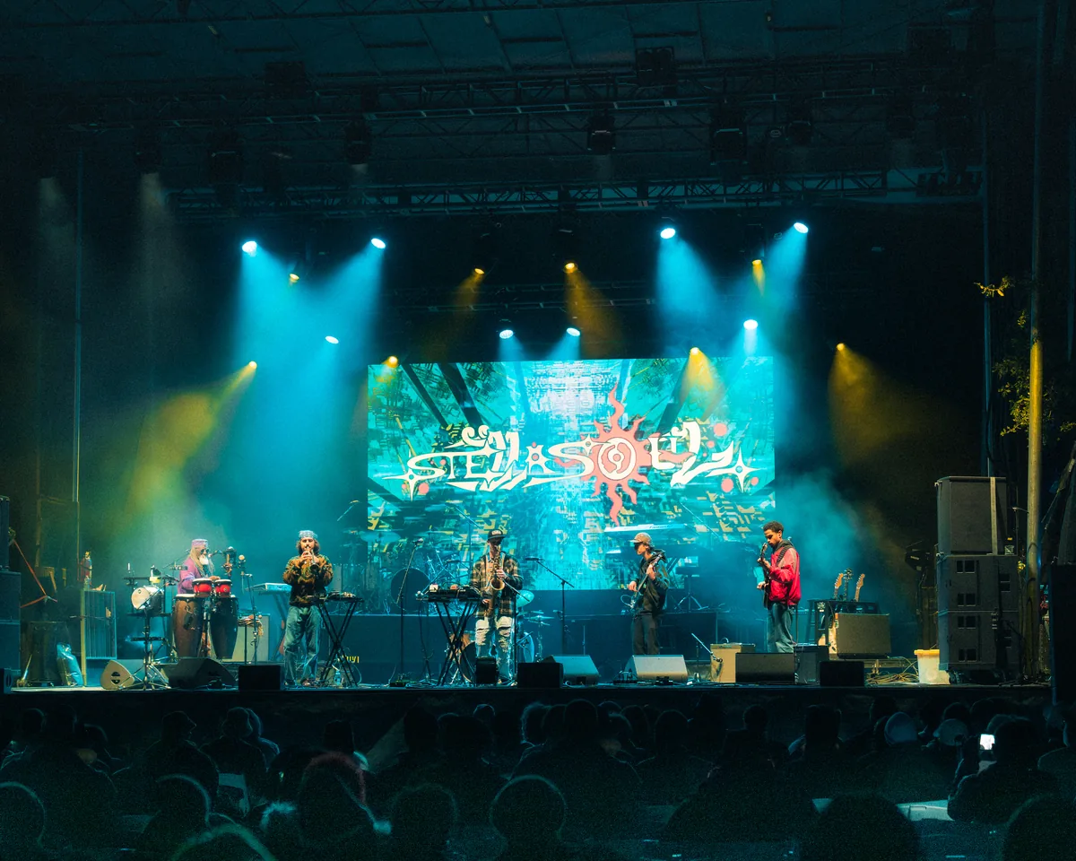 Band performs on stage with colorful lighting at Fort Mose Jazz Festival