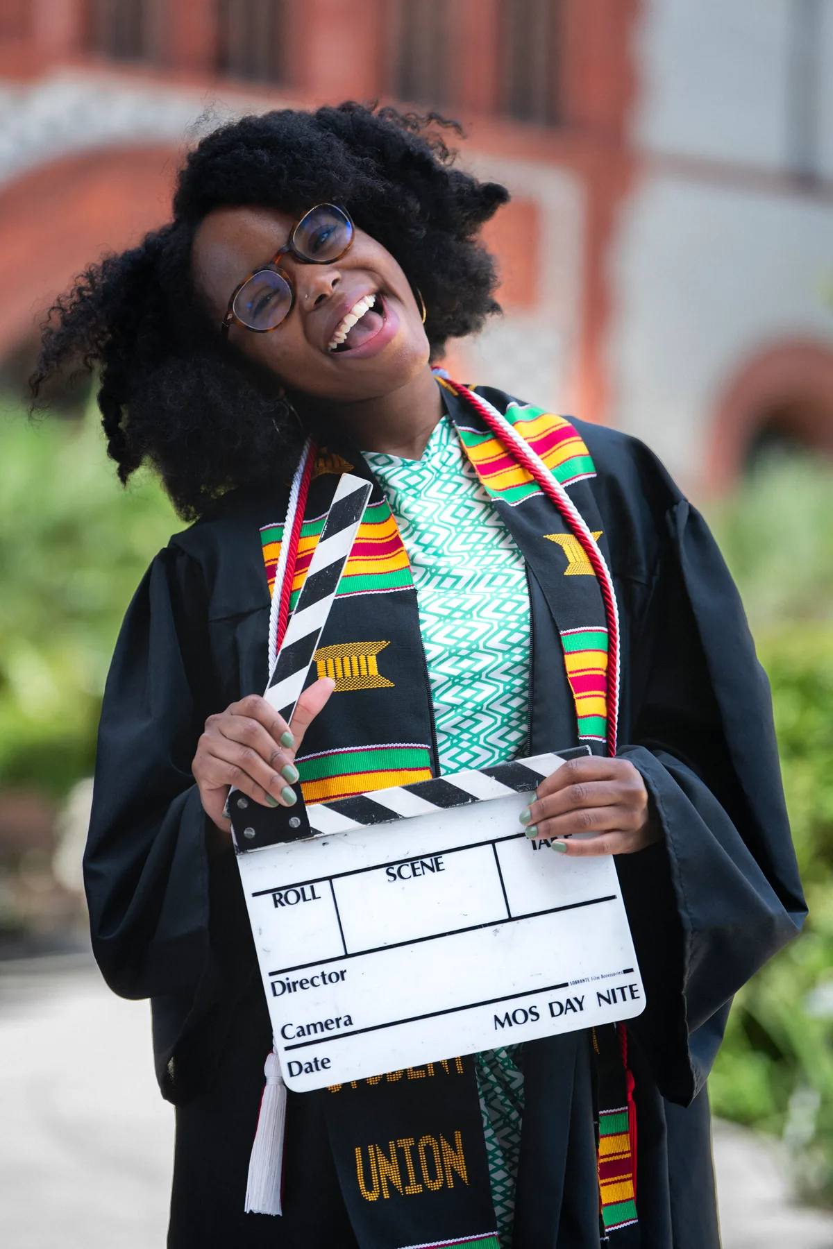 Joyful Flagler College graduate laughing candidly during photo session