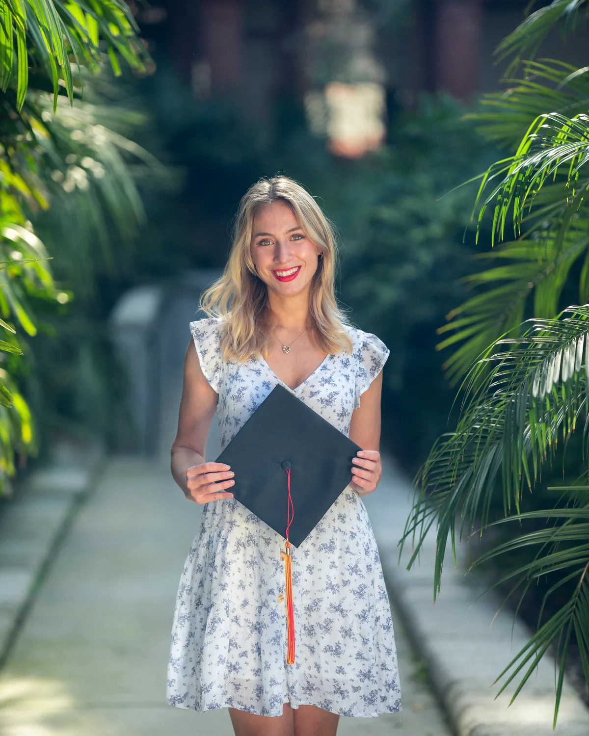 Flagler College graduate holding her cap on the historic St. Augustine campus — First Sight Films