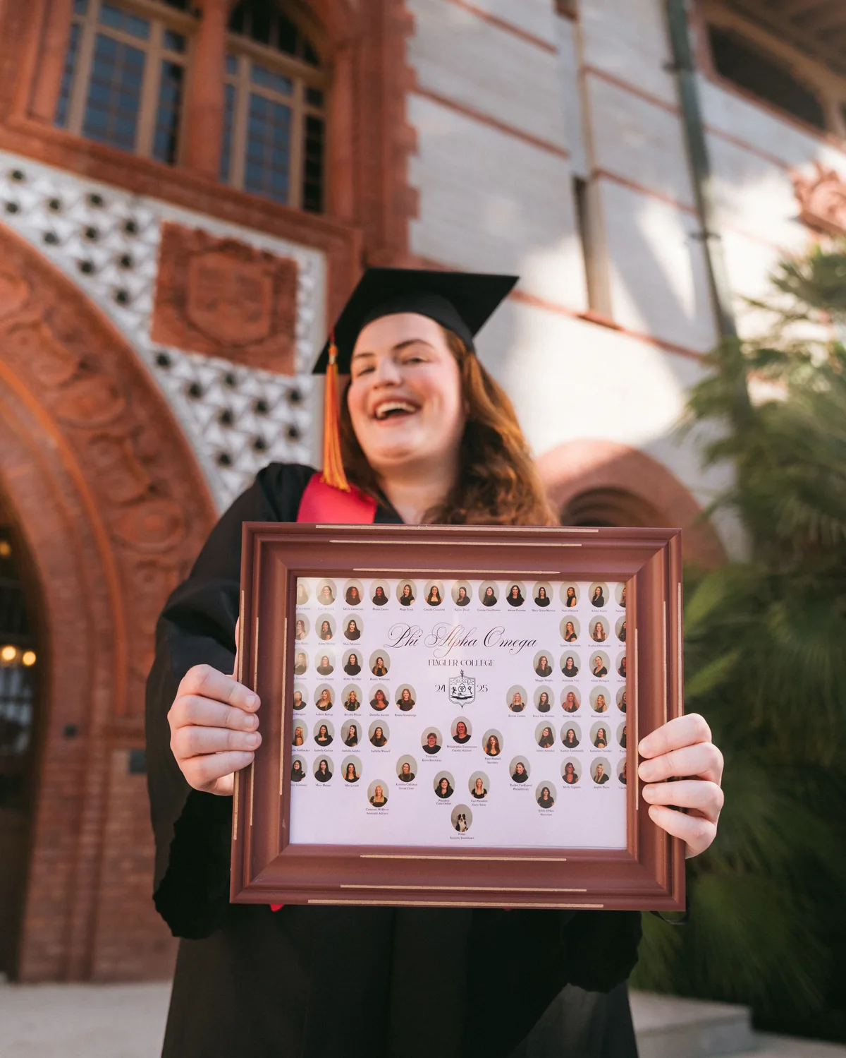 Flagler College graduate celebrating with a decorated cap at a Ponce Hall archway — First Sight Films
