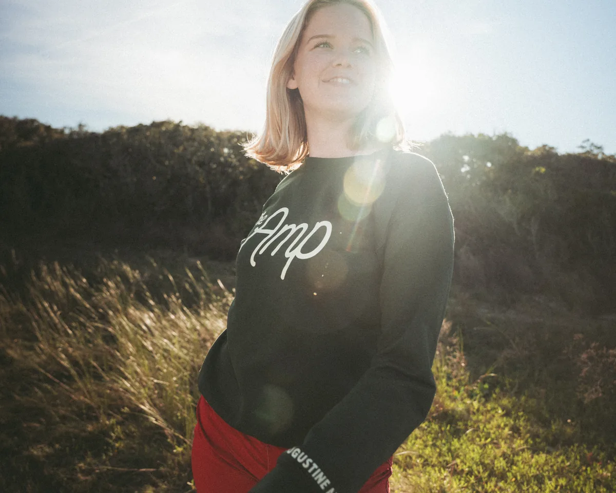 Model in Amp sweatshirt with natural sun flare at Anastasia State Park