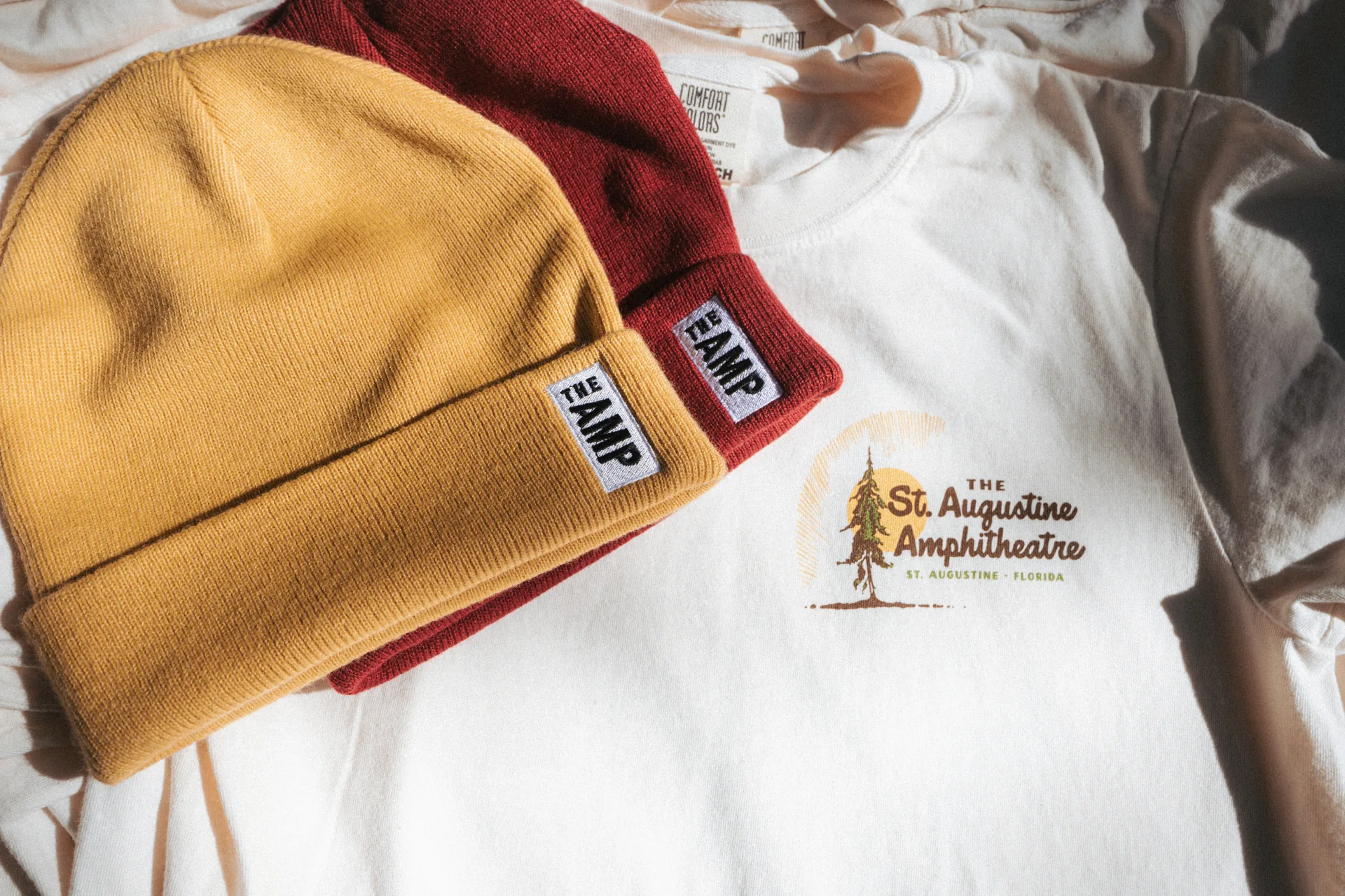 The Amp beanies and St. Augustine Amphitheatre tee, apparel product photography