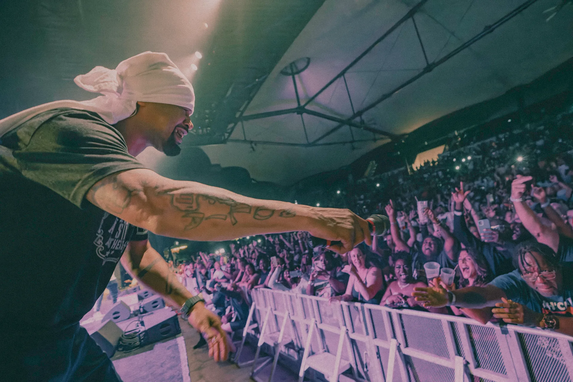 Juvenile performing and reaching toward an excited crowd at the St. Augustine Amphitheatre in St. Augustine, Florida